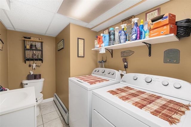 27 Nixon St, Cumberland, RI 02864 - laundry room with a baseboard radiator, separate washer and dryer, and light tile patterned flooring