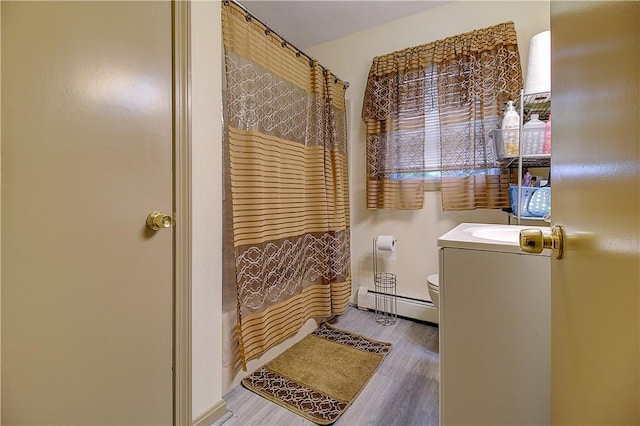 10 E St Unit 316, Cranston, RI 02920 - full bathroom featuring a baseboard heating unit, wood finished floors, vanity, and shower / bath combo