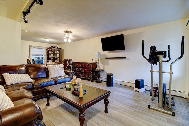 10 E St Unit 316, Cranston, RI 02920 - living area with wood finished floors, a baseboard radiator, rail lighting, and a ceiling fan