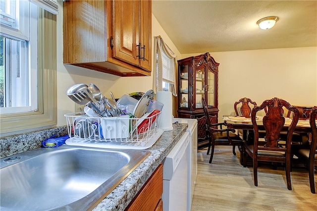 10 E St Unit 316, Cranston, RI 02920 - kitchen with white dishwasher, brown cabinets, and light wood-type flooring