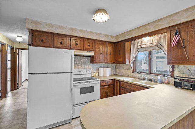 321 Beckwith St, Cranston, RI 02910 - kitchen featuring white appliances, under cabinet range hood, light countertops, light flooring, and a peninsula