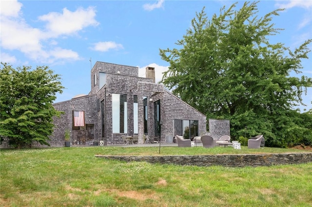 668 Indian Ave, Middletown, RI 02842 - back of house featuring a chimney and a lawn