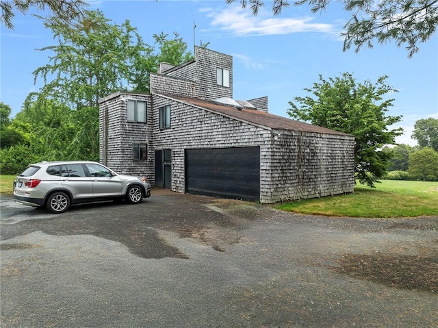 668 Indian Ave, Middletown, RI 02842 - view of side of home featuring an attached garage and driveway