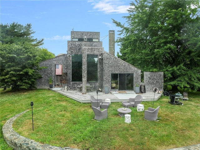 668 Indian Ave, Middletown, RI 02842 - rear view of property featuring a chimney, a yard, and a deck