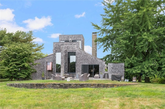 668 Indian Ave, Middletown, RI 02842 - rear view of house with a lawn and a chimney