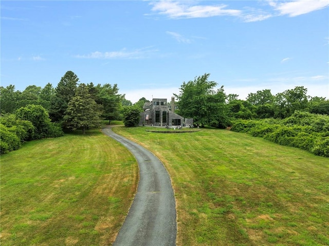 668 Indian Ave, Middletown, RI 02842 - view of green lawn featuring asphalt driveway