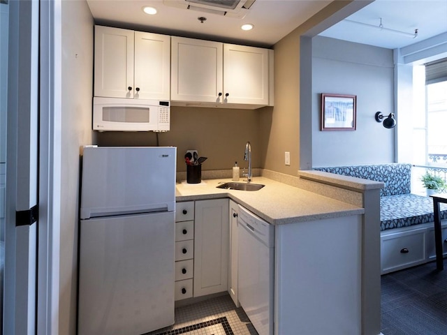 65 Weybosset St Unit 211, Providence, RI 02903 - kitchen with white appliances, light countertops, a peninsula, white cabinets, and tile patterned flooring