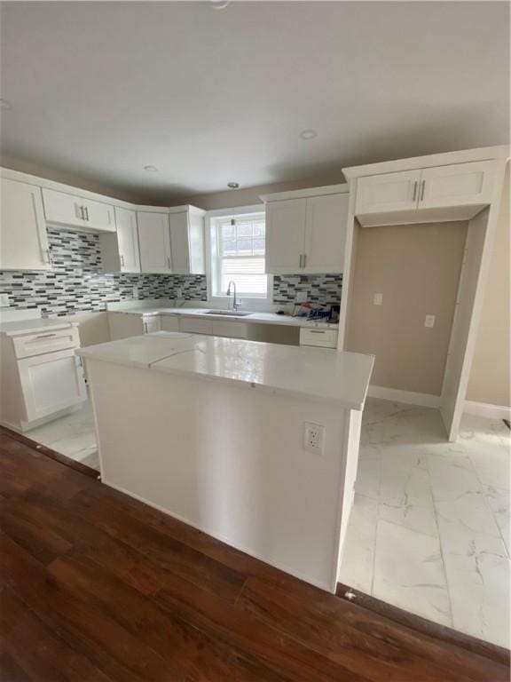 11 Chambers St, Providence, RI 02907 - kitchen featuring a center island, tasteful backsplash, white cabinetry, light countertops, and recessed lighting