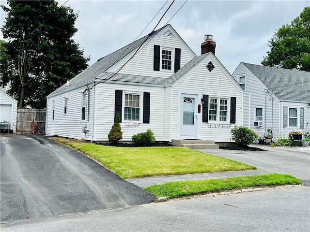 74 Leslie St, Cranston, RI 02910 - view of front facade with a chimney and roof with shingles