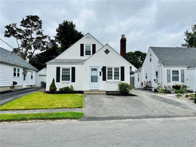 74 Leslie St, Cranston, RI 02910 - bungalow-style house with a chimney and a front yard