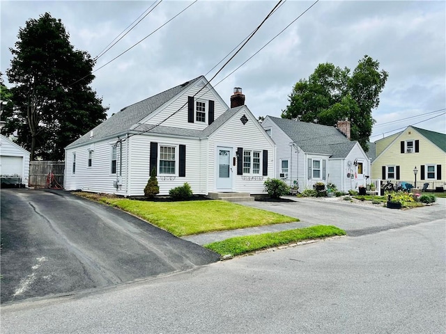 74 Leslie St, Cranston, RI 02910 - new england style home with a chimney and a shingled roof