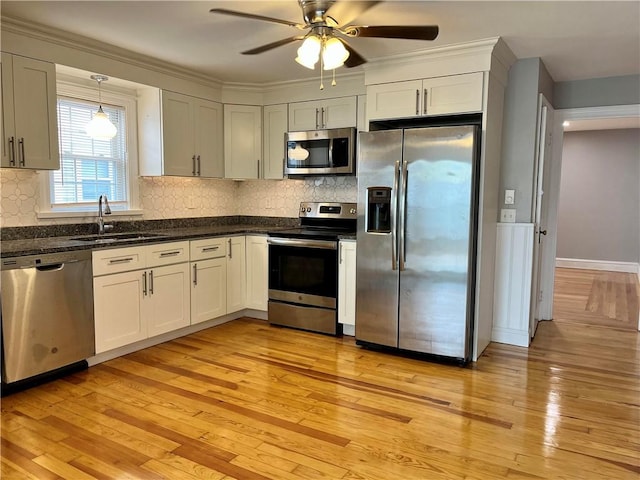 74 Leslie St, Cranston, RI 02910 - kitchen featuring appliances with stainless steel finishes, ceiling fan, light wood finished floors, and decorative backsplash