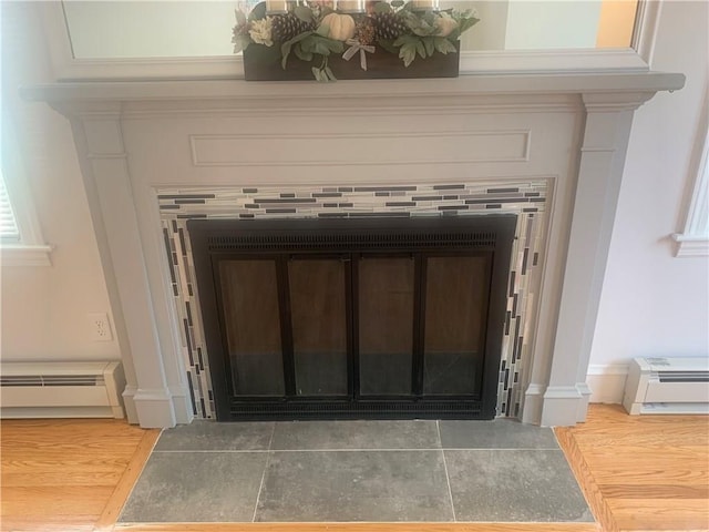 74 Leslie St, Cranston, RI 02910 - detailed view of a baseboard radiator, ornate columns, and wood finished floors