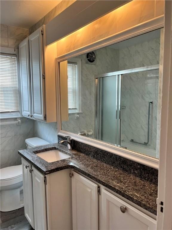 74 Leslie St, Cranston, RI 02910 - full bathroom featuring vanity, a shower stall, and tile walls