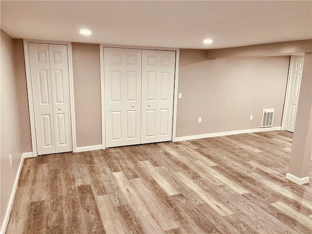 74 Leslie St, Cranston, RI 02910 - unfurnished bedroom with two closets, wood finished floors, and recessed lighting