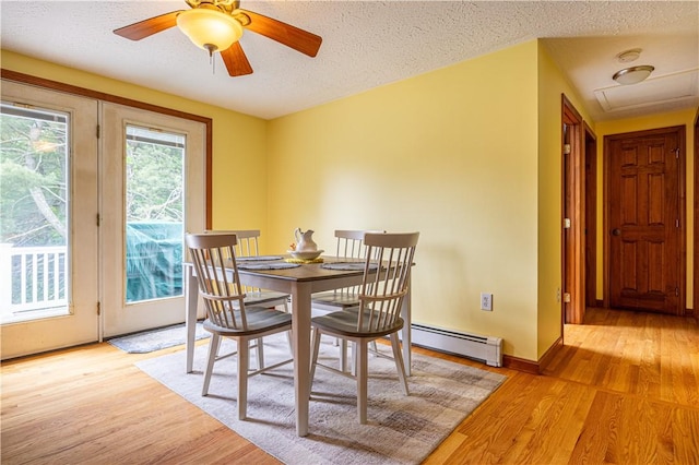 1846 E Wallum Lake Rd, Burrillville, RI 02859 - dining space featuring a baseboard radiator, light wood-style flooring, a textured ceiling, and ceiling fan
