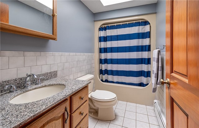 1846 E Wallum Lake Rd, Burrillville, RI 02859 - full bath with baseboard heating, tile walls, vanity, tile patterned flooring, and a skylight