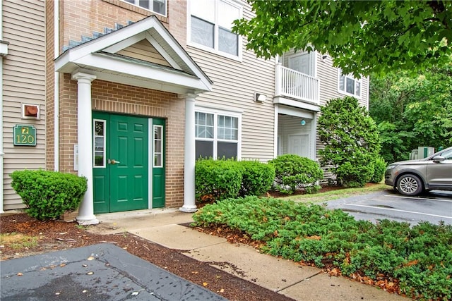 120 Mill St Unit 103, Woonsocket, RI 02895 - entrance to property featuring brick siding and uncovered parking