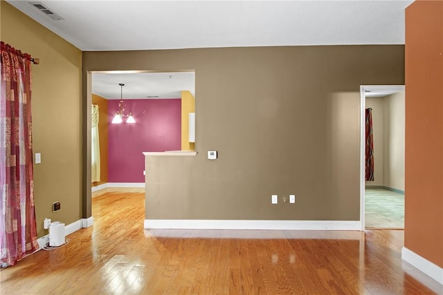 120 Mill St Unit 103, Woonsocket, RI 02895 - empty room with wood finished floors and a chandelier