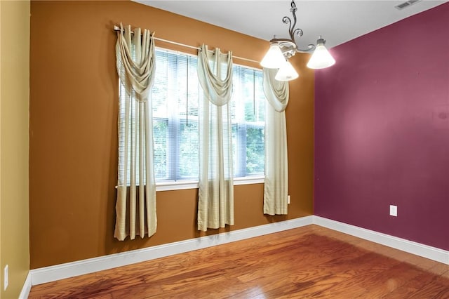 120 Mill St Unit 103, Woonsocket, RI 02895 - empty room with a chandelier and wood finished floors