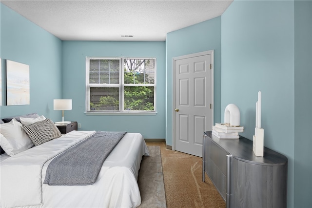 120 Mill St Unit 103, Woonsocket, RI 02895 - bedroom with light colored carpet and a textured ceiling