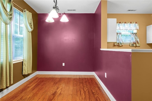 120 Mill St Unit 103, Woonsocket, RI 02895 - unfurnished dining area featuring wood finished floors and plenty of natural light