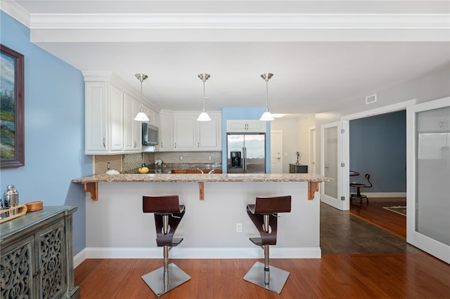 333 Atwells Ave Unit 302, Providence, RI 02903 - kitchen with appliances with stainless steel finishes, a peninsula, dark wood-style flooring, and white cabinetry
