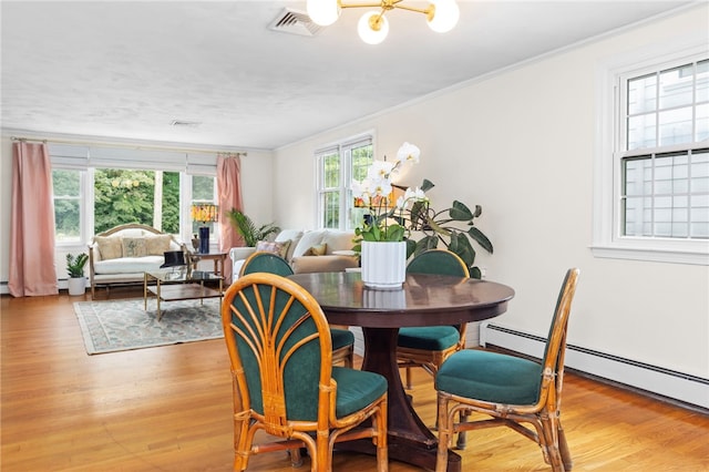 112 Edgewood Blvd, Providence, RI 02905 - dining area featuring ornamental molding, light wood-type flooring, a baseboard heating unit, and a chandelier