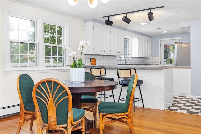 112 Edgewood Blvd, Providence, RI 02905 - dining area with light flooring, track lighting, and a baseboard heating unit