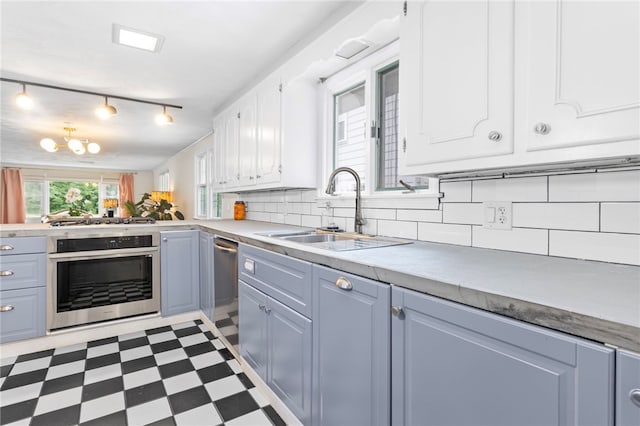 112 Edgewood Blvd, Providence, RI 02905 - kitchen featuring stainless steel appliances, dark flooring, tasteful backsplash, light countertops, and white cabinetry