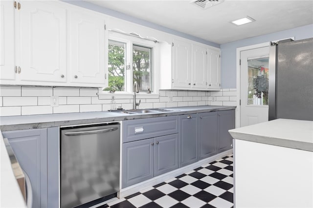 112 Edgewood Blvd, Providence, RI 02905 - kitchen featuring appliances with stainless steel finishes, light floors, white cabinetry, backsplash, and light countertops