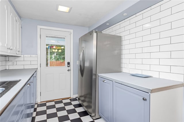 112 Edgewood Blvd, Providence, RI 02905 - kitchen featuring dark floors, stainless steel fridge, backsplash, light countertops, and white cabinetry