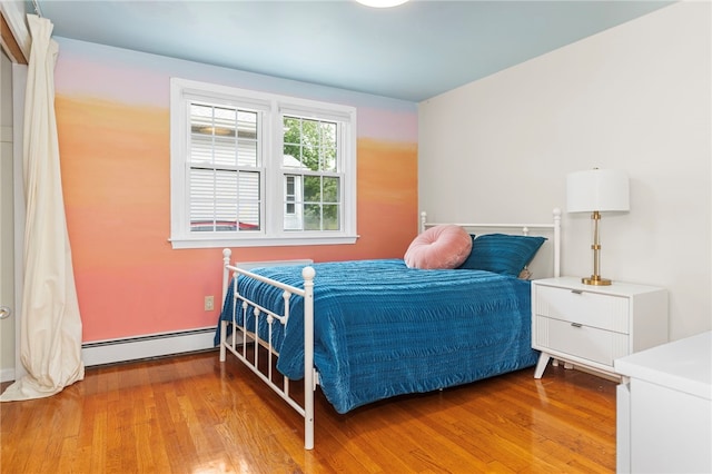 112 Edgewood Blvd, Providence, RI 02905 - bedroom featuring baseboard heating and wood finished floors