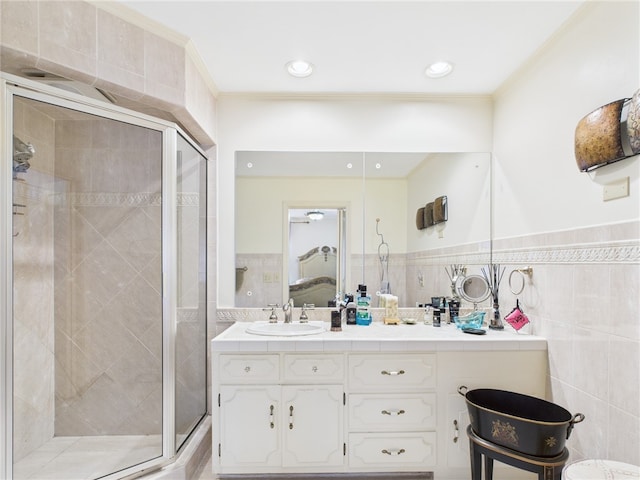 150 Central Ave, Johnston, RI 02919 - ensuite bathroom featuring double vanity, a shower stall, tile walls, crown molding, and a wainscoted wall