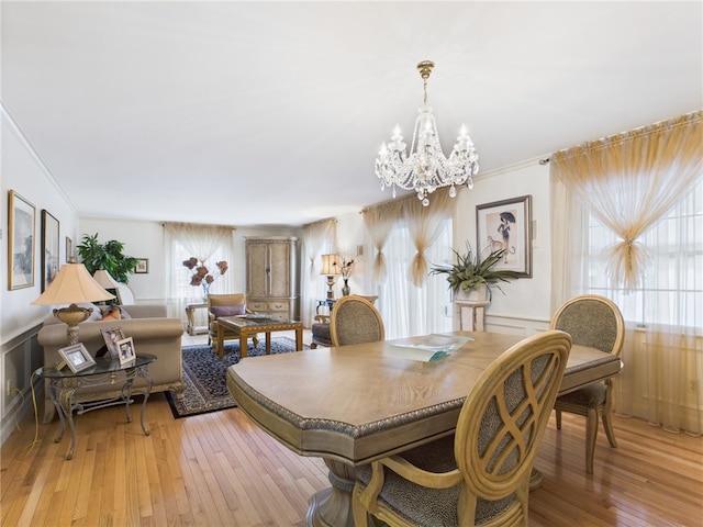 150 Central Ave, Johnston, RI 02919 - dining room with a chandelier, a wainscoted wall, light wood finished floors, ornamental molding, and a decorative wall
