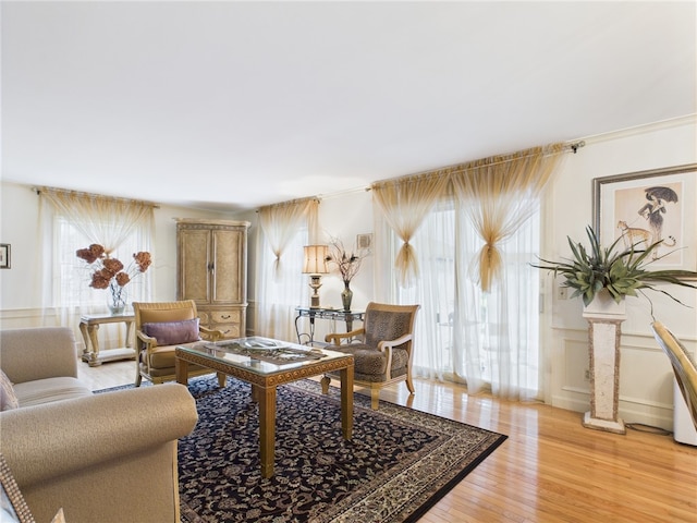 150 Central Ave, Johnston, RI 02919 - living area featuring light wood-style floors, wainscoting, and a decorative wall
