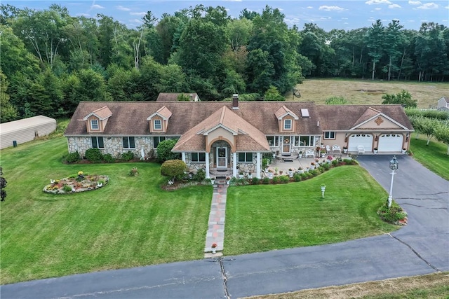 240 Smith St, Attleboro, MA 02703 - new england style home with stone siding, asphalt driveway, a front yard, and covered porch