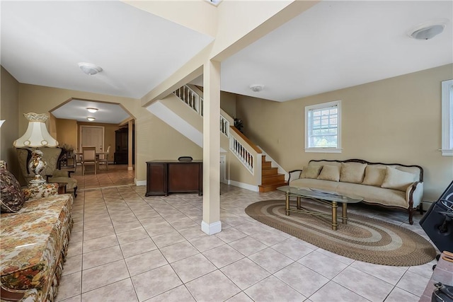 240 Smith St, Attleboro, MA 02703 - living area with stairway, light tile patterned floors, and arched walkways