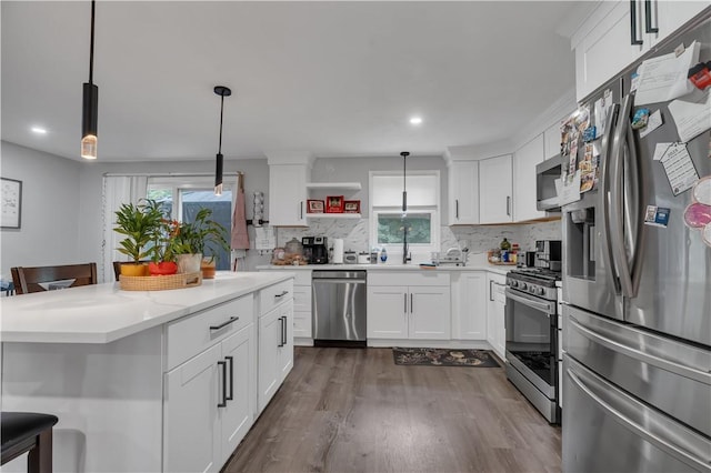 8 Gale Ct, North Providence, RI 02904 - kitchen with stainless steel appliances, dark wood-style flooring, a kitchen bar, decorative backsplash, and recessed lighting