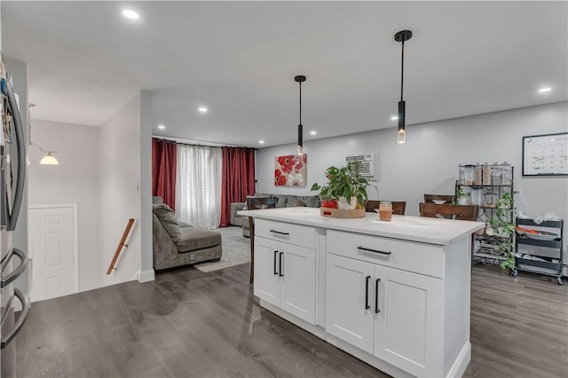 8 Gale Ct, North Providence, RI 02904 - kitchen with dark wood-style floors, open floor plan, white cabinets, hanging light fixtures, and refrigerator