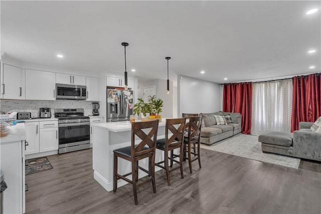 8 Gale Ct, North Providence, RI 02904 - kitchen with stainless steel appliances, open floor plan, light countertops, dark wood-style flooring, and recessed lighting