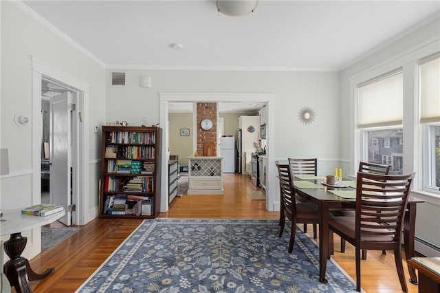 179 Cole Ave Unit 2, Providence, RI 02906 - dining area featuring wood finished floors, crown molding, and a baseboard radiator