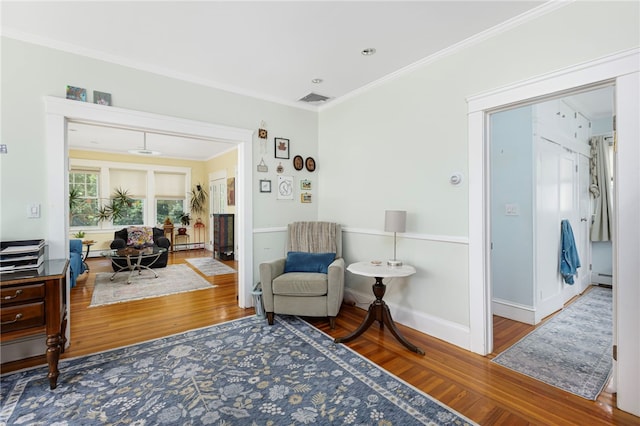 179 Cole Ave Unit 2, Providence, RI 02906 - sitting room with ornamental molding, wood finished floors, baseboard heating, and a baseboard heating unit