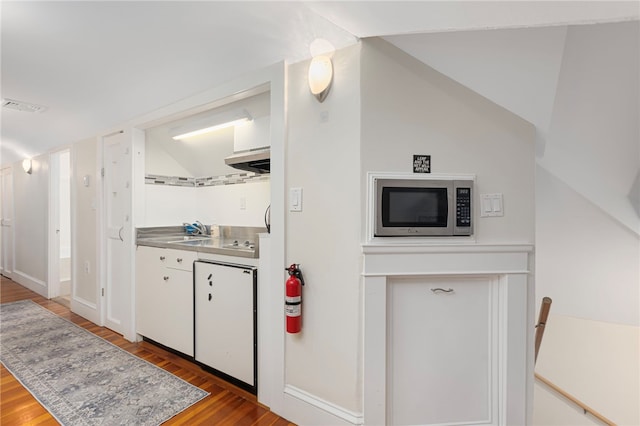 179 Cole Ave Unit 2, Providence, RI 02906 - kitchen featuring stainless steel microwave, stainless steel counters, light wood-style flooring, white cabinets, and vaulted ceiling