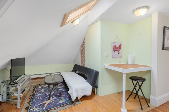 179 Cole Ave Unit 2, Providence, RI 02906 - sitting room featuring wood finished floors, vaulted ceiling, and a baseboard heating unit