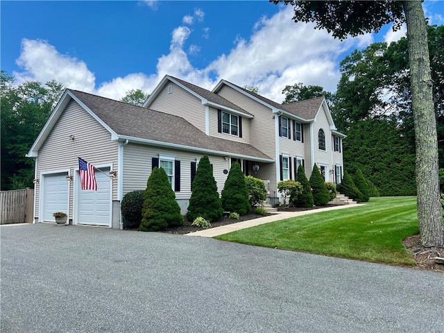 35 E Lantern Rd, Smithfield, RI 02917 - view of front of house with driveway, a garage, a front lawn, and a shingled roof