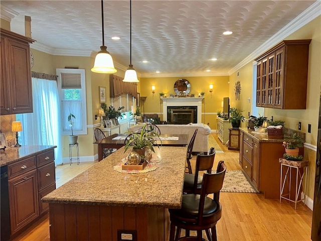 35 E Lantern Rd, Smithfield, RI 02917 - kitchen featuring a kitchen bar, open floor plan, light wood-style floors, recessed lighting, and light stone counters