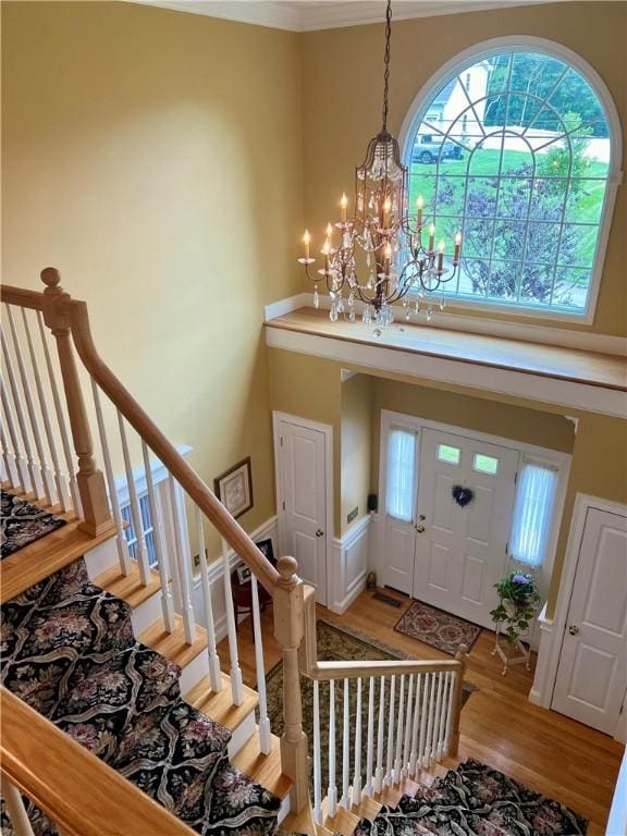 35 E Lantern Rd, Smithfield, RI 02917 - entryway with a chandelier, a towering ceiling, wood finished floors, and crown molding