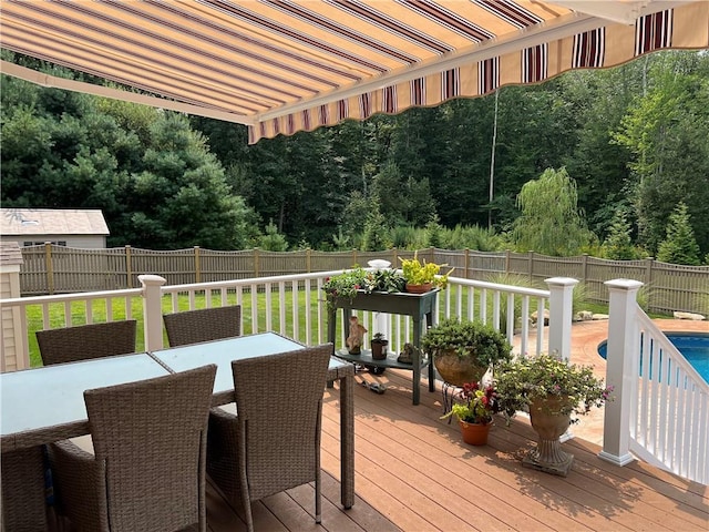 35 E Lantern Rd, Smithfield, RI 02917 - wooden deck with outdoor dining space, a fenced backyard, and a wooded view
