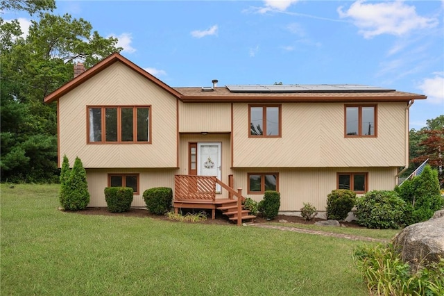 29 Teakwood Dr W, Coventry, RI 02816 - split foyer home with a front yard, a chimney, and roof mounted solar panels